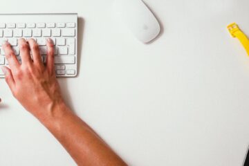 Youth worker completing shift notes alone at night in a residential house